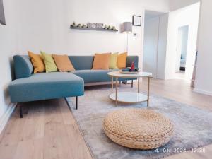Bright living room with teal sofa